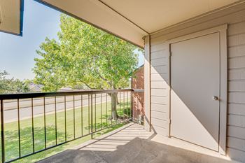 A white door is on the side of a house.